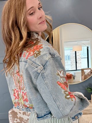 Back view of cropped denim jacket with hand-beaded and embroidered design