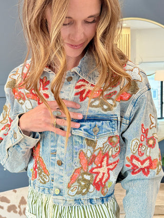 Close-up of hand beading on the back of a denim jacket