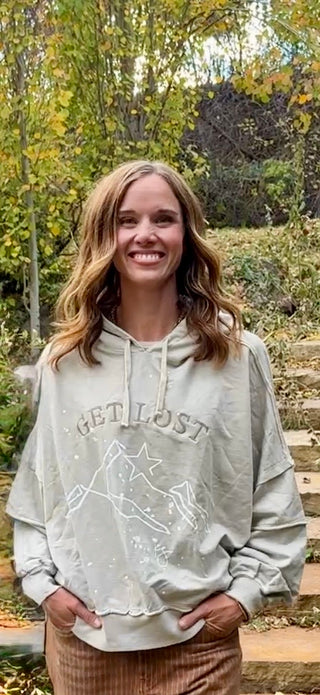 Close front view of the Get Lost hoodie showing the embroidery and relaxed fit