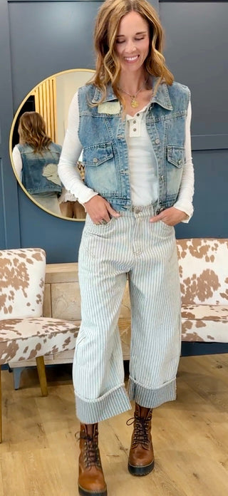 Full-length front view of a model wearing the Free Fallin' Flower Quilted Patchwork Denim Vest