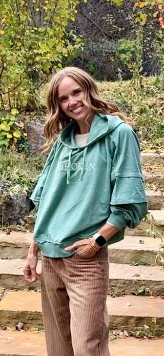 Women's Unbroken Moose hoodie in Alpine Lake blue-green, front view with "Unbroken" embroidery