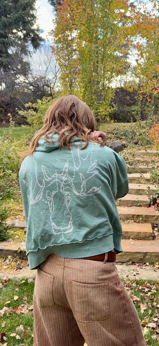 Back of the Unbroken Moose hoodie with Kayla's one-line moose art