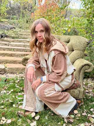 Woman crouching beside a green armchair in the Peaceful Easy Feelin' cream and cinnamon set