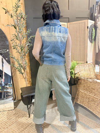 Full-length back view of the ROOTED & Rare Denim Vest with wide-leg jeans